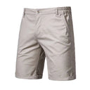 A pair of slim fit, straight leg light grey tailored golf shorts with a visible button and zipper.