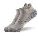 Grey performance golf and training ankle socks with cushioned heel, arch support, and moisture-wicking fabric