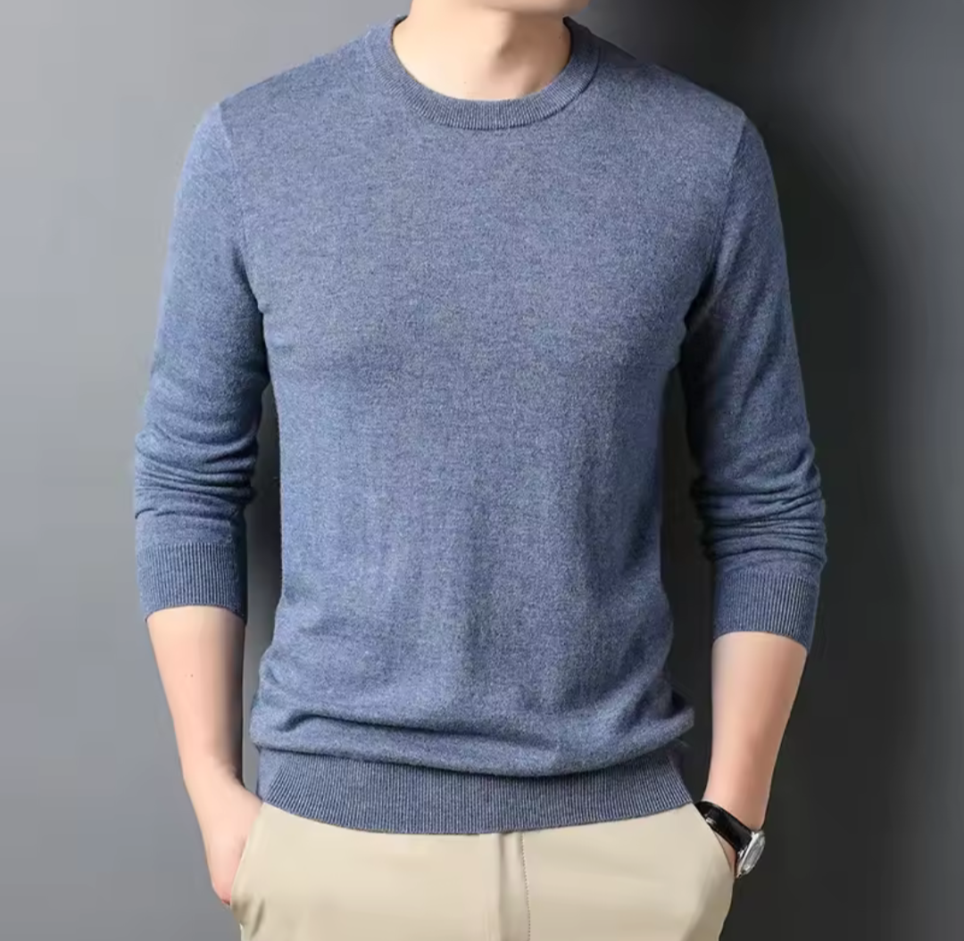 Golf Sweater in muted blue knitted fabric with a classic round neck, long sleeves, and ribbed cuffs and hem