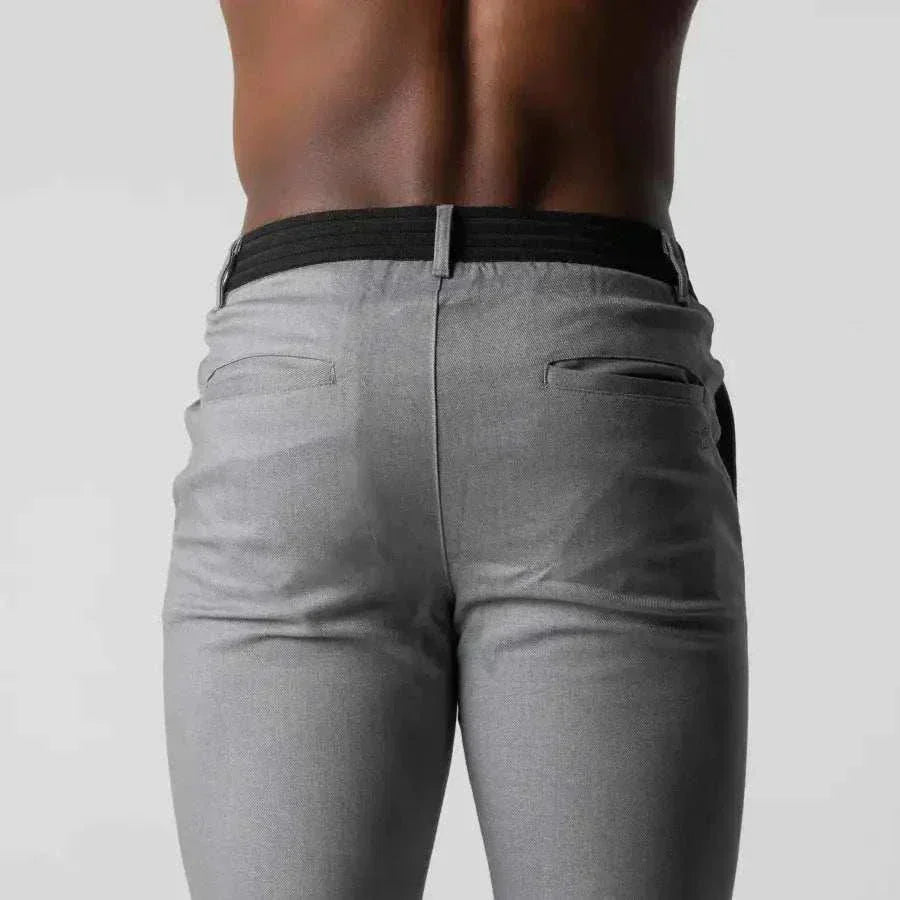Grey golf trousers with flexi-waistband pants worn by a person on a plain background