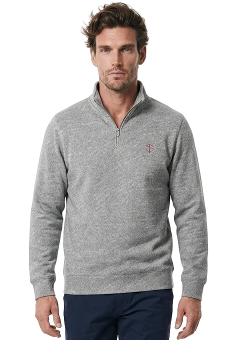 A man modeling a light gray quarter-zip  golf sweater with a small embroidered logo on the chest, paired with navy blue trousers and white sneakers, against a plain white studio background.