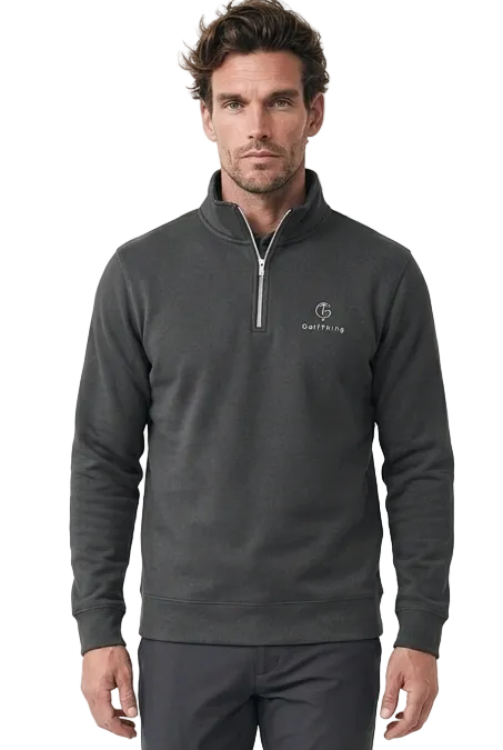 A man modeling a dark gray quarter-zip golf jumper and matching dark grey golf trousers against a clean white studio background.