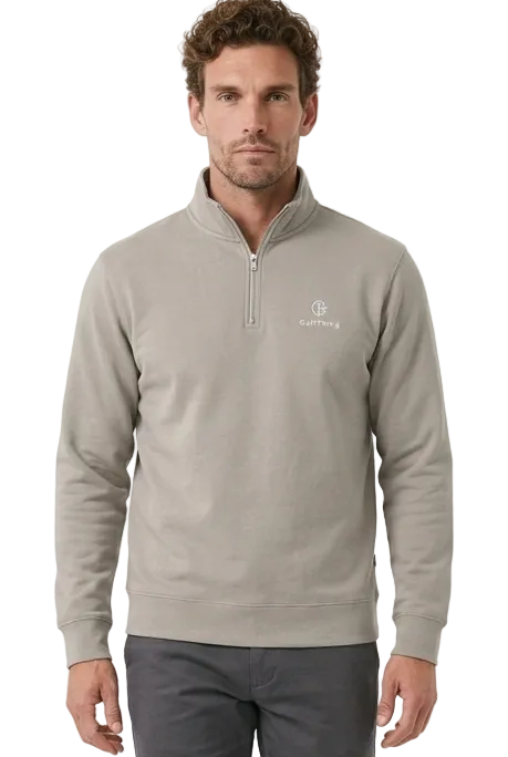 A man modeling a light gray quarter-zip golf jumper and dark grey golf trousers against a plain white studio background.