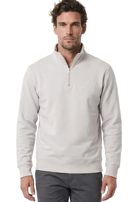 A man modeling a light gray quarter-zip golf jumper and dark grey golf trousers against a plain white studio background.