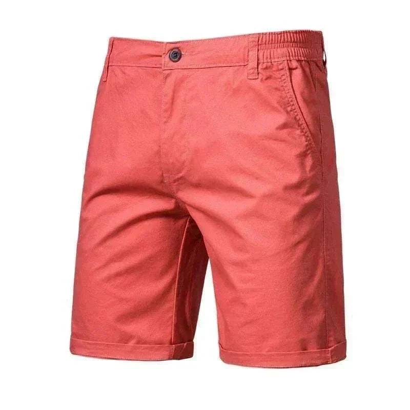 Golf Shorts in coral red with a smooth solid-color finish, button closure, elastic waistband detail and cuffed hems