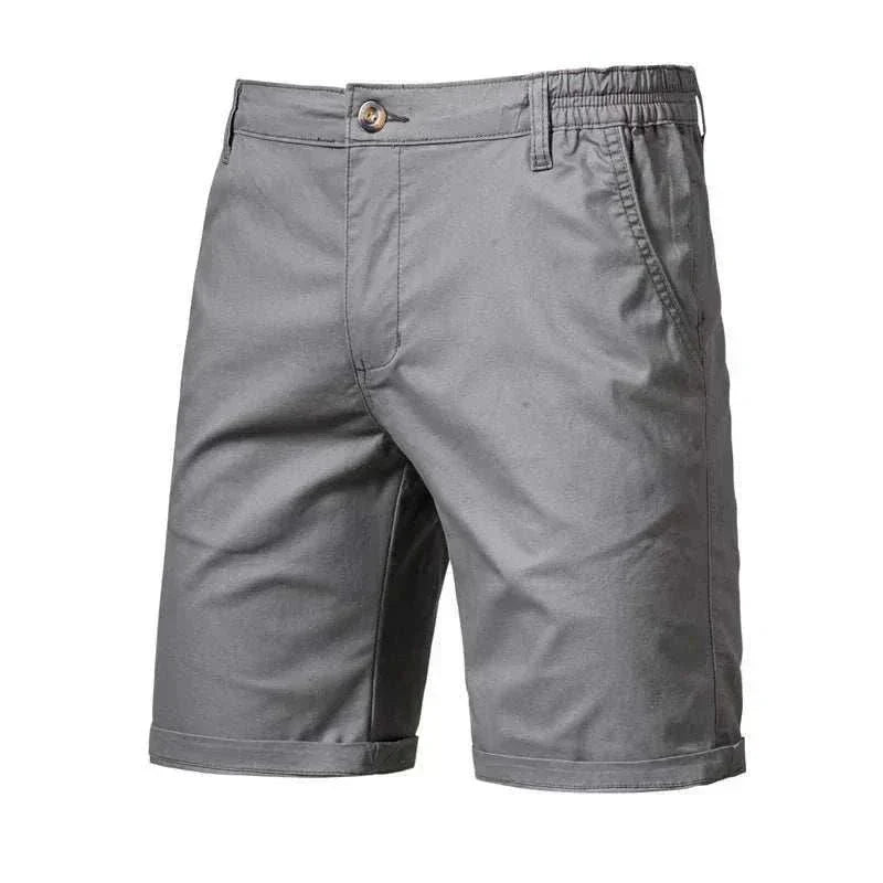 Golf shorts in solid dark grey woven fabric, featuring a tailored straight-leg fit, elasticated waistband and cuffed hems