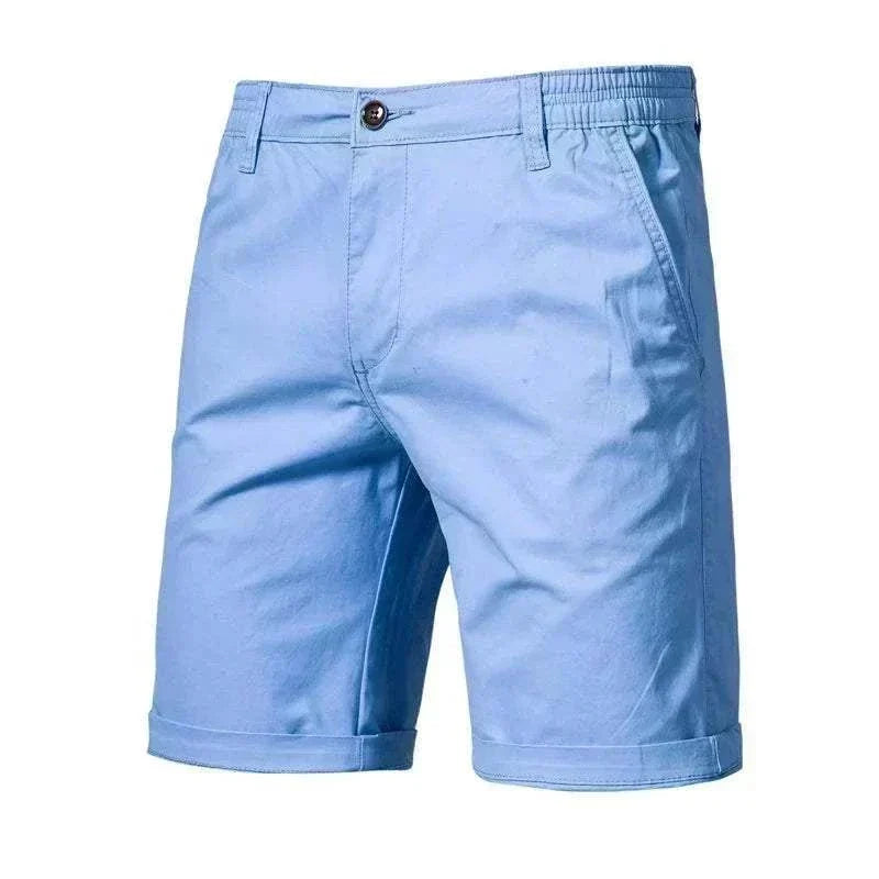 Golf Shorts in light blue cotton-like fabric, with a button waistband, side pockets, elastic back waist and rolled cuffs