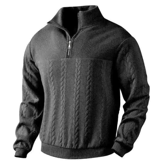 Golf sweater in charcoal grey knit with raised cable panels, textured sleeves, and a quarter-zip stand collar